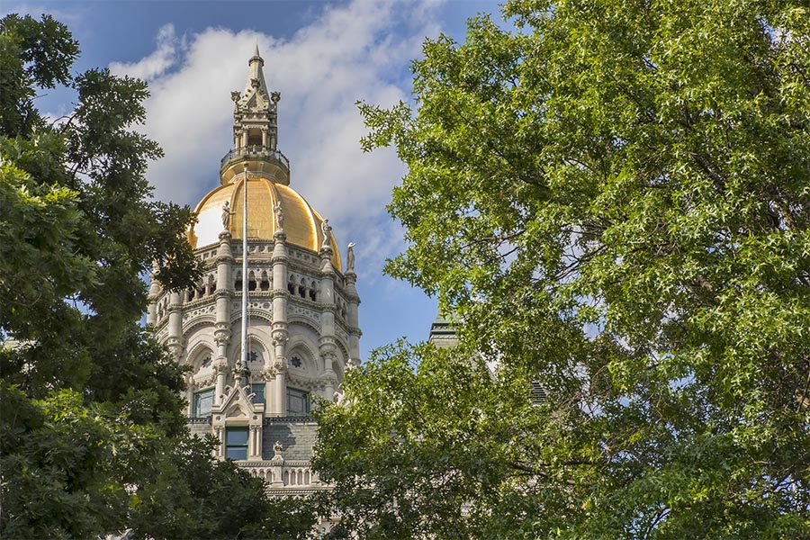 About Our Agency - Connecticut State Capitol Building, the Gold Dome Rising above the Leafy Green Trees